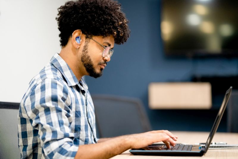 Photo of employee working on laptop