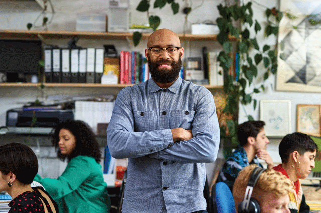 Employee standing in an office space. 