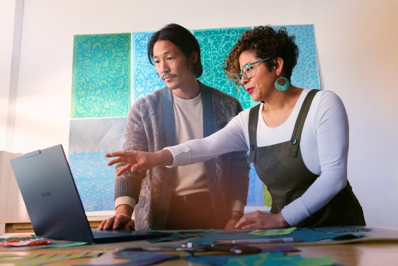 Employees working together on laptop