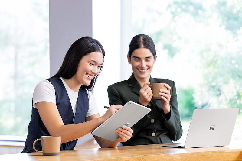 Photo of two employees working together